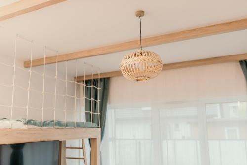 a chandelier hanging from a ceiling in a kitchen at Apartament Dar Pomorza 20m do Plaży Ustronie Apartments in Ustronie Morskie