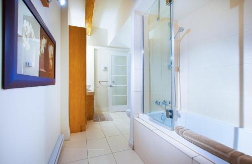 a bathroom with a shower and a sink and a toilet at La Casa St-Jean - OLD QUEBEC in Quebec City