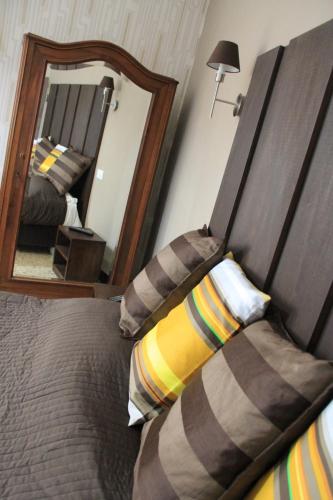 a bedroom with a bed with a large mirror at Hotel Bologna in Genova