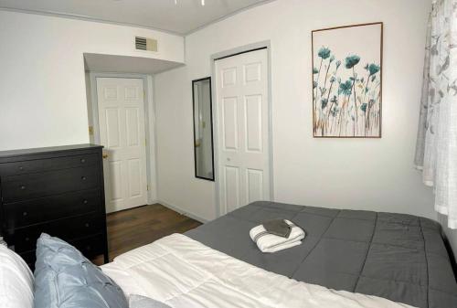 a bedroom with a bed with a hat on it at *King bed/3bds house Near Naval Base & 6Flags* in Waukegan