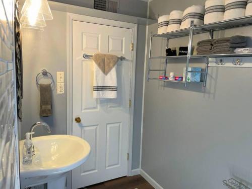 a bathroom with a sink and a white door at *King bed/3bds house Near Naval Base & 6Flags* in Waukegan