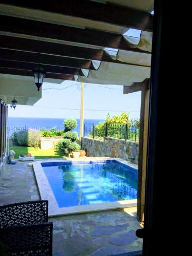 a swimming pool with a view of the ocean at Villa Defne in Tekirdağ