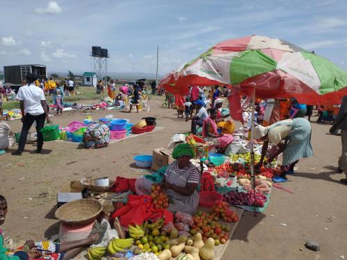 a group of people at a market with fruits and vegetables at Maasai homestay camping in Sekenani