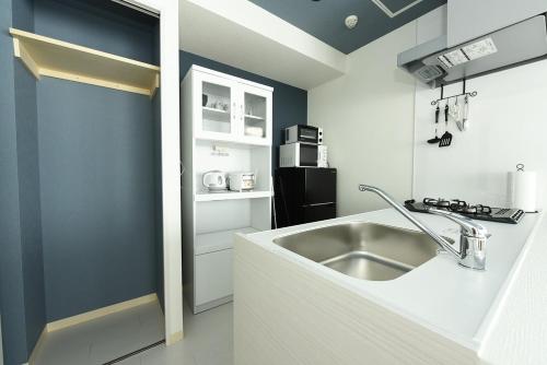 a kitchen with a sink and a counter top at Hills Garden Hondori - Vacation STAY 12112 in Sapporo
