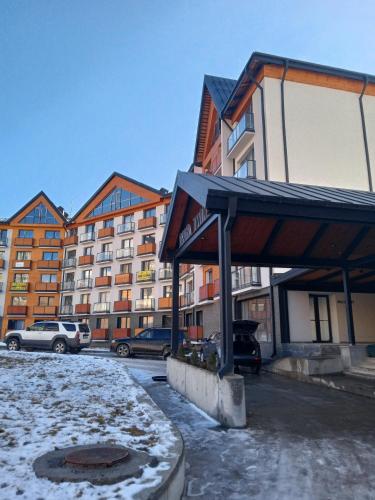 a parking lot in front of a large building at New Twins 333 in Gudauri