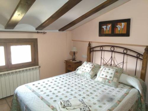 a bedroom with a large bed and a window at Casa Concha in Alcalá de la Selva