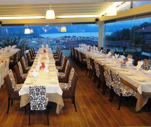 a large dining room with long tables and chairs at Frontzu Politia in Ioannina