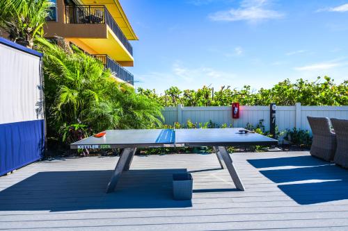 a ping pong table in the middle of a patio at Anna Maria Beach Resort in Holmes Beach