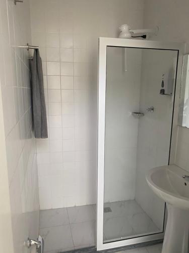 a bathroom with a shower and a sink at Amilcar Cabral Loft in Praia