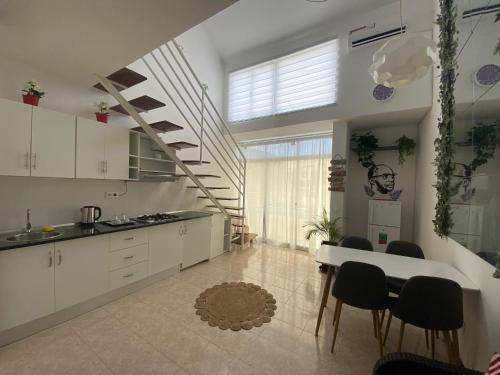 a kitchen with a staircase and a table and chairs at Amilcar Cabral Loft in Praia