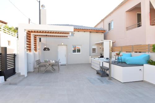 a patio with a kitchen and a dining area at Kameiros Treasure Villa in Kalavárda
