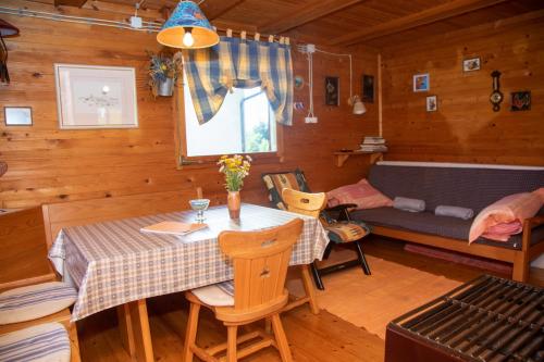 a dining room with a table and a couch in a cabin at My dream house in Vrhovci