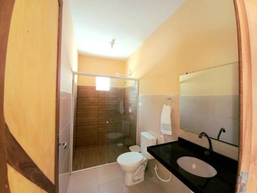 a bathroom with a sink and a toilet and a shower at Casa DeTe Caldas-Barbalha in Barbalha