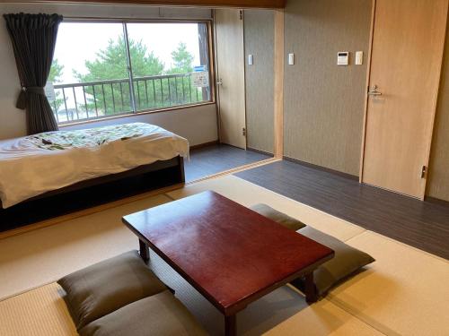 a living room with a bed and a coffee table at Koya TRIBE - Vacation STAY 83089v in Oishi