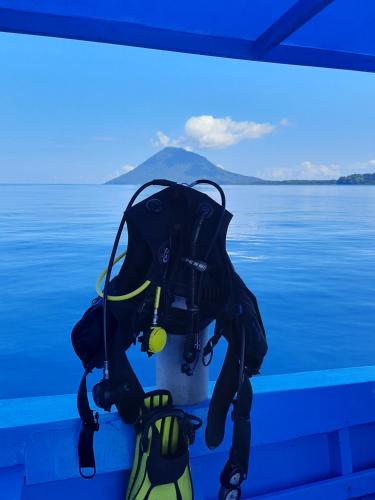 a backpack sitting on the back of a boat on the water at Blue Shark Divers Bunaken in Bunaken