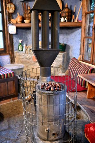 a wood stove with somenuts inside of a room at Kivotos Epavlis in Prespes