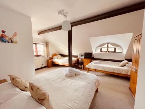a bedroom with two beds in a room at The Plough Inn Boddington in Daventry