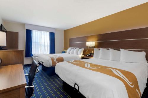 a hotel room with two beds and a television at Quality Inn in Lee