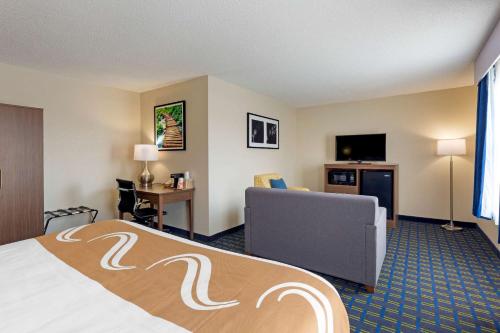 a hotel room with a bed and a couch at Quality Inn in Lee
