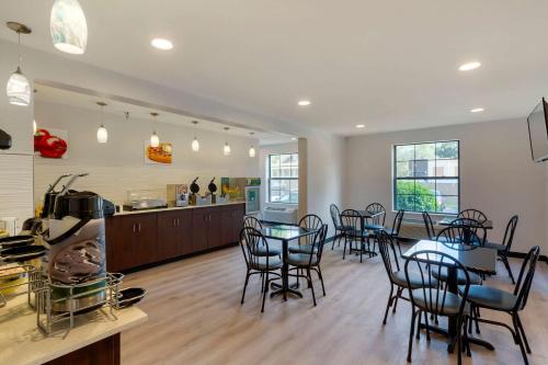 a dining room and kitchen with tables and chairs at Quality Inn in Lee