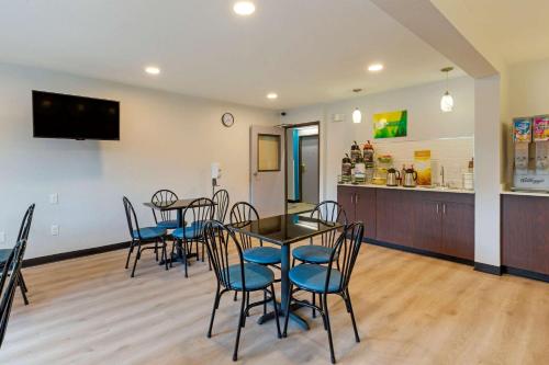 a dining room with chairs and a table and a counter at Quality Inn in Lee