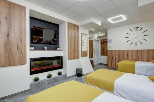 a hotel room with two beds and a fireplace at Riverside Inn - dunaparti szuterén in Győr