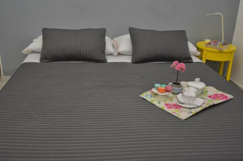 a bed with a tray of food on it at Il Vicolo B&B in Milazzo