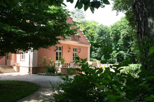 a pink house with trees in front of it at Willa Różana in Nałęczów