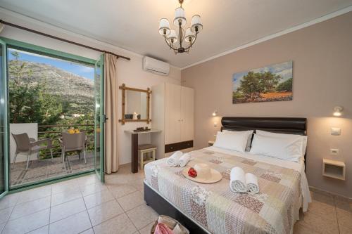 a bedroom with a bed and a balcony at Minas Apartments in Divarata