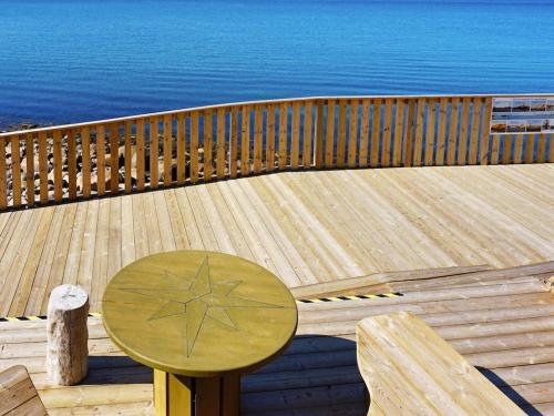 a wooden deck with a wooden table with a star on it at 4 person holiday home in LYSEKIL-By Traum in Lysekil