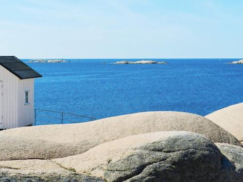 a large rock next to a building and the ocean at 4 person holiday home in LYSEKIL-By Traum in Lysekil
