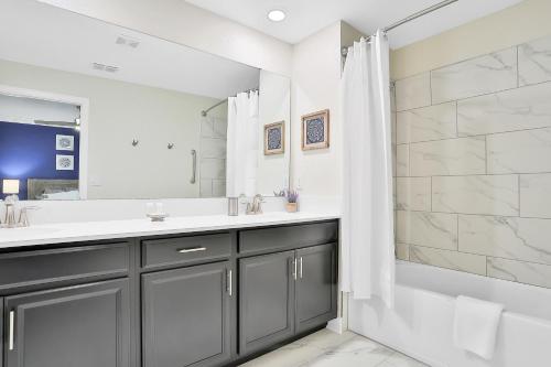 a bathroom with a shower and a sink and a tub at Royale Palm in Kissimmee