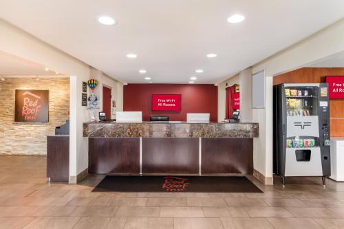 a restaurant lobby with a counter and a refrigerator at Red Roof Inn Albuquerque - Midtown in Albuquerque