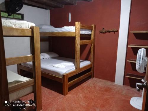 a group of bunk beds in a room at Mi Cabaña El Maderal in Capurganá