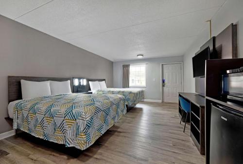 a hotel room with two beds and a flat screen tv at Motel 6 Corbin KY in Corbin