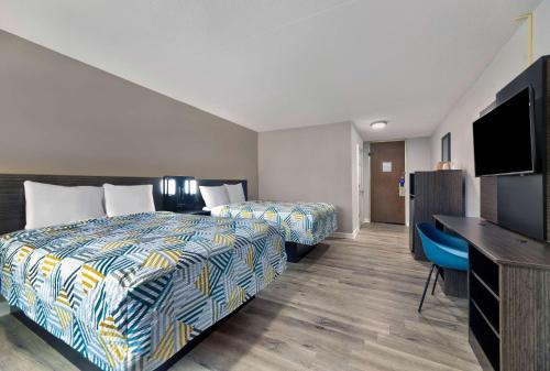 a hotel room with two beds and a flat screen tv at Motel 6 Corbin KY in Corbin