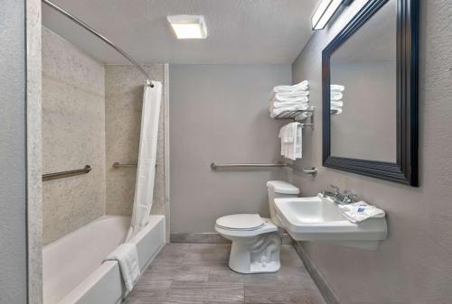 a bathroom with a sink and a toilet and a bath tub at Motel 6 Corbin, KY in Corbin