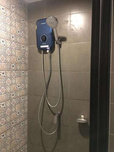 a shower in a bathroom with a blow dryer at Lacasita HuaHin by Pahmai in Hua Hin