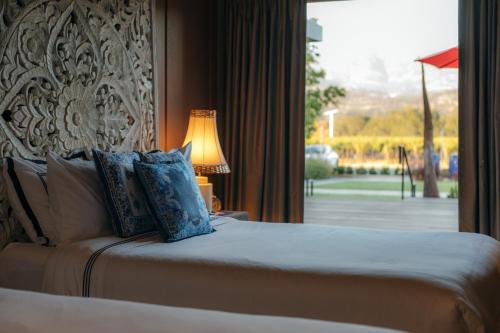 a bed in a hotel room with a window at Bann at Oak Knoll Napa in Napa