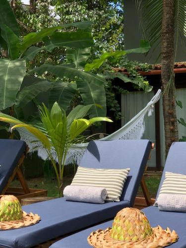 a patio with two chairs and two watermelons on a table at Kûara Pipa in Pipa