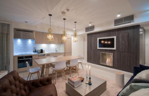 a kitchen and living room with a table and a fireplace at Loft Niseko in Kutchan
