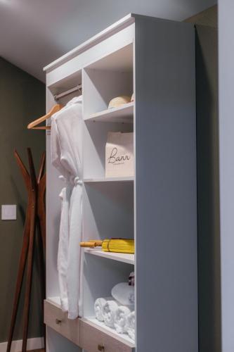 a closet with white shelves and towels at Bann at Oak Knoll Napa in Napa