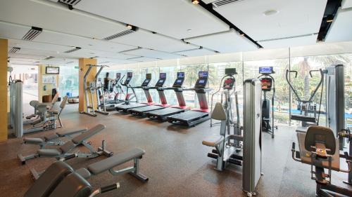 a gym with a bunch of treadmills and machines at ONE15 Marina Sentosa Cove Singapore in Singapore