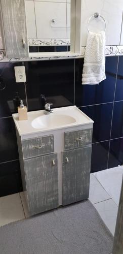 a bathroom with a white sink and a mirror at Casa Deni in Nova Petrópolis