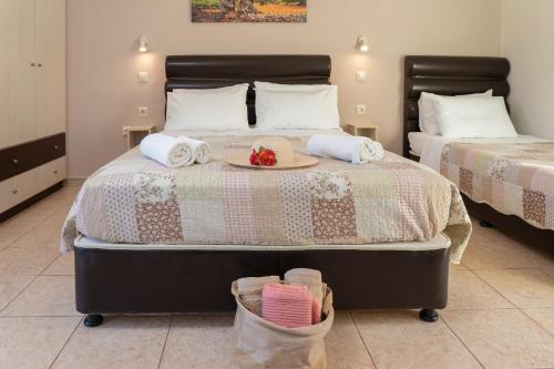 a bedroom with a bed with a tray of fruit on it at Minas Apartments in Divarata