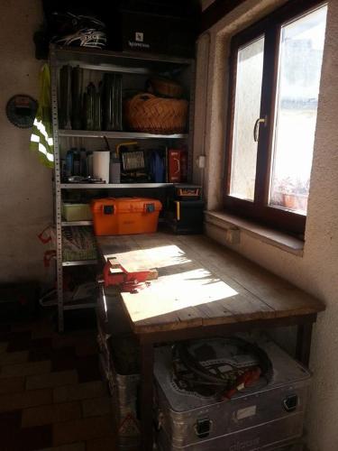 a room with a wooden table and a window at al Merlo Olivo, rural istrian house in Buje