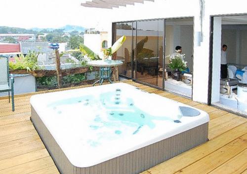 a hot tub on the roof of a house at Sky Garden Hotel by RedDoorz in Roxas City