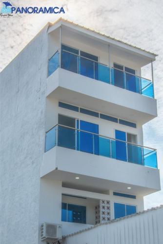 a building with blue balconies on the side of it at Apartahotel Sueños Libres Necoclí in Necoclí