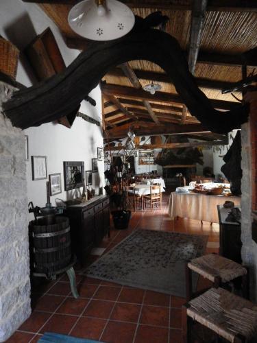 a living room with a table and chairs in a building at Affittcamere Jannas in Orgosolo