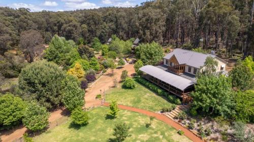 an aerial view of a house with a train at Noble River Estate in Dwellingup